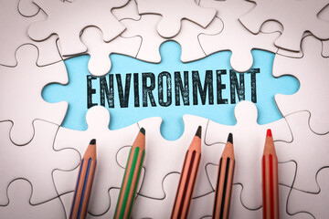 Environment. White puzzle pieces and colored pencils