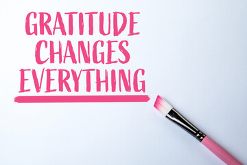 Gratitude Changes Everything. Painted Brush and Pink Text on a white background