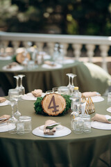 Rustic table number four on wood slice. Natural outdoor setting