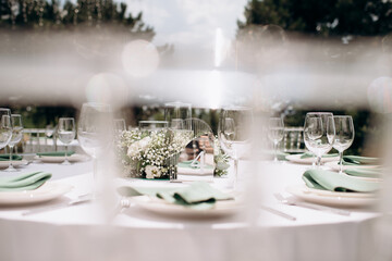 Outdoor table setting with flowers and number four. Elegant, natural atmosphere