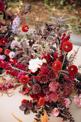Close-up of a rich and colorful floral arrangement with dark red and purple flowers
