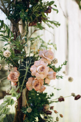 Bohemian floral arrangement with peach roses and pompom flowers