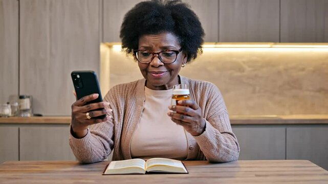 Senior person reading a medicine leaflet using a mobile phone.