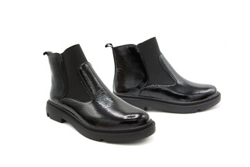Fashionable classic patent leather boots on heels isolated on white background. View from all sides. Demi-season shoes.