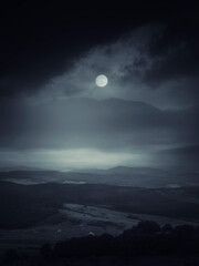 halloween night landscape with full moon over mountain