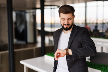 Young businessman checking the time in office
