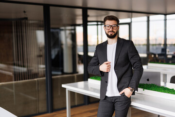 Fototapeta premium Businessman posing confident and positive at workplace office with space