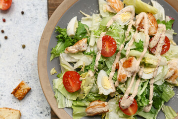 Plate with tasty chicken Caesar salad on white background, closeup
