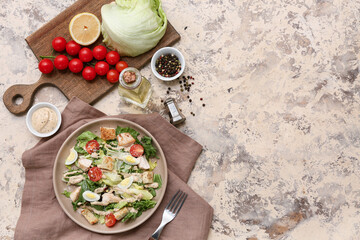 Plate with tasty chicken Caesar salad and ingredients on grunge background