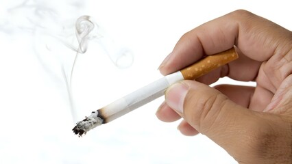 Hand holding a lit cigarette with smoke rising, symbolizing smoking habits, tobacco consumption and lifestyle choices related to health risks and addiction