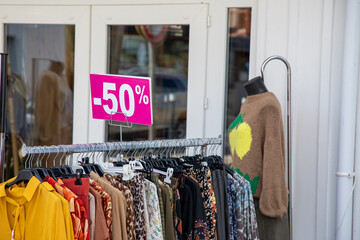 Big sales special offer in end of season of shop at fashion store display with text 50% on pink...