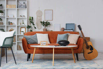Interior of living room with sofa, table and musical instruments