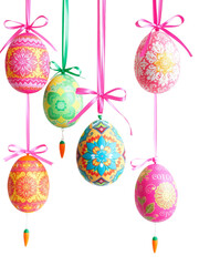 A vibrant image showcasing several intricately decorated Easter eggs hanging from ribbons