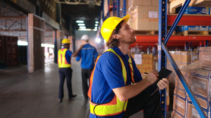 Portrait of warehouse workers are reviewing the list of items based on the documentation