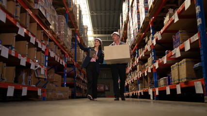 Business woman and warehouse workers are reviewing the list of items based on the documentation