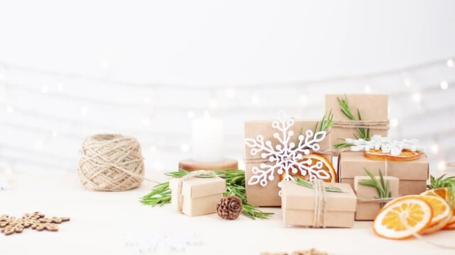 Eco friendly packaging gifts in craft paper on wooden table. Zero waste Christmas holiday concept. Close up, copy space