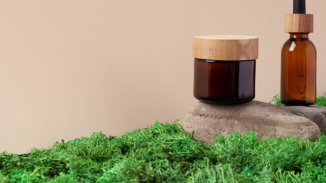 Skin care products on pastel beige background with moss, wood. Close up, copy space.
