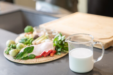 The ingredients, including chicken wings, chilli, kaffir lime leaves and lemongrass, are prepared to be cooked for a famous thai dish, Green Curry.