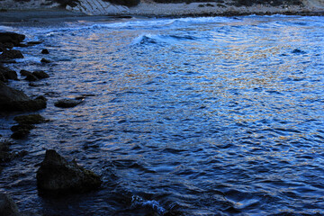 ripples of water, reflection of light on the sea at sunset