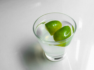Juice lime pure fresh in glass,  lemon with water cocktail, summer tropical citrus fruit hight...