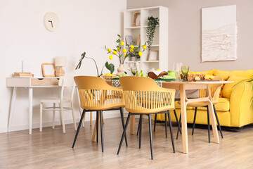 Interior of dining room with table setting and beautiful lemon tree branches