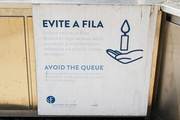 Sign about leaving candles to avoid queues at Fatima, Portugal