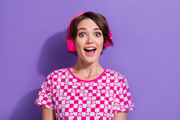 Photo of cheerful positive girl meloman wear trendy pink clothes listen mp3 player isolated on purple color background