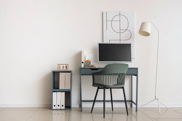 Comfortable workplace with computer in interior of office