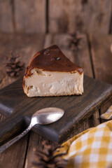 San Sebastian cheesecake on a wooden board on a wooden table