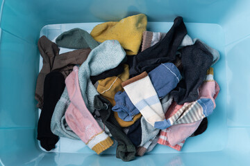 Men's and women's socks cluttered in storage boxes