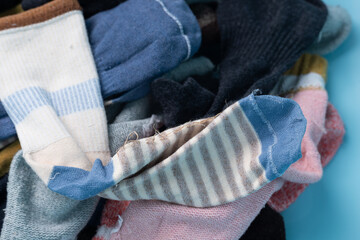 Men's and women's socks cluttered in storage boxes