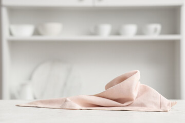 Pink napkin on white table in modern kitchen