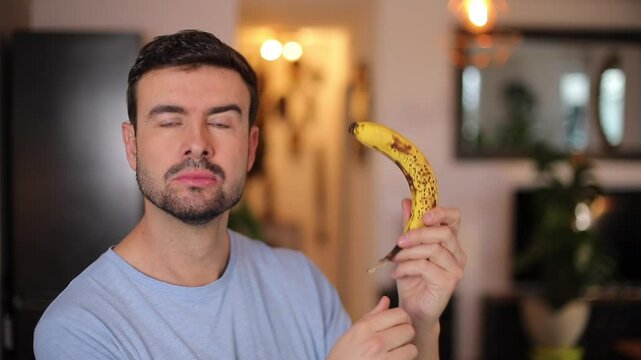 Handsome man eating a banana 