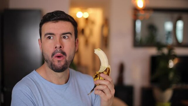 Handsome man eating a banana 
