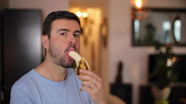 Handsome man eating a banana 