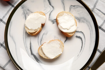 Plate of tasty bruschetta with processed cheese on napkin, closeup