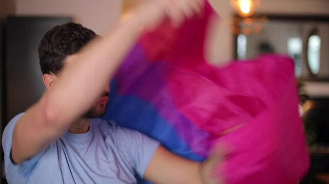 Proud man waving the bisexual flag 