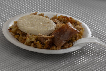 Typical Tolima suckling pig with rice, a typical Colombian dish.