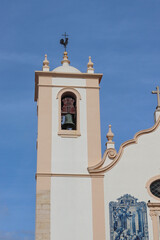 Historic Portuguese church with traditional azulejo tile murals and Baroque architectural details...