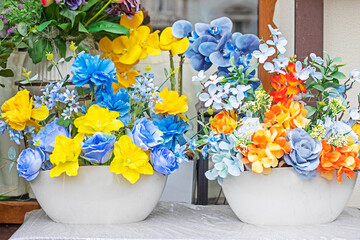 delicate yellow, blue and orange flowers in vases
