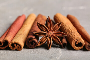 Anise star and cinnamon on grey background, closeup