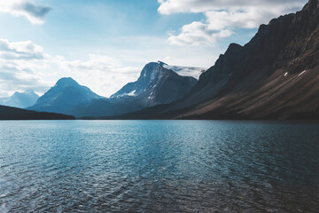 landscape and nature photograph shot during a summer journey in canada, with lakes, rocky mountains, animals and clouds through wide pine tree forests