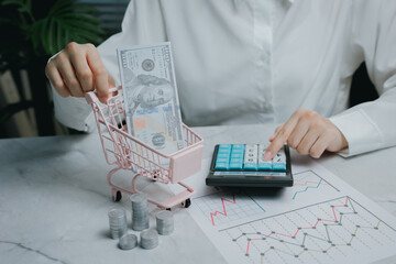 Financial planning with calculator and cash in cart, Business concept