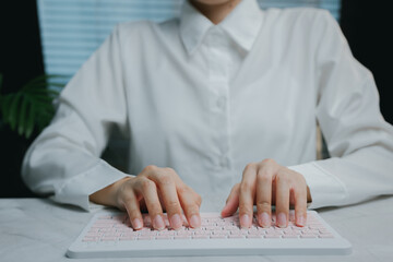 Close-up of hands typing on modern white keyboard, Business concept