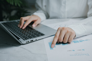 Business report analysis with laptop and charts, Business concept
