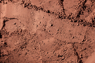 Natural dark brown cocoa powder textured background, closeup, top view