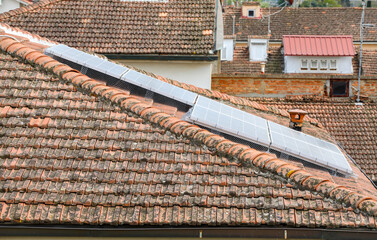 Solar panels with bird protection mesh on a tiled roof