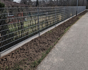 Proceed to fasten the rest of the mesh using the method, Attach tension wire to chain link fence,...