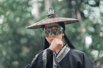 Chinese warriors wearing old traditional costumes. An elegant warrior in a conventional black robe...