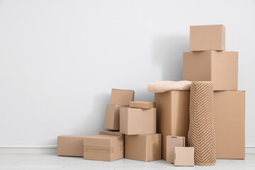 Many different parcels and pillow near white wall in room